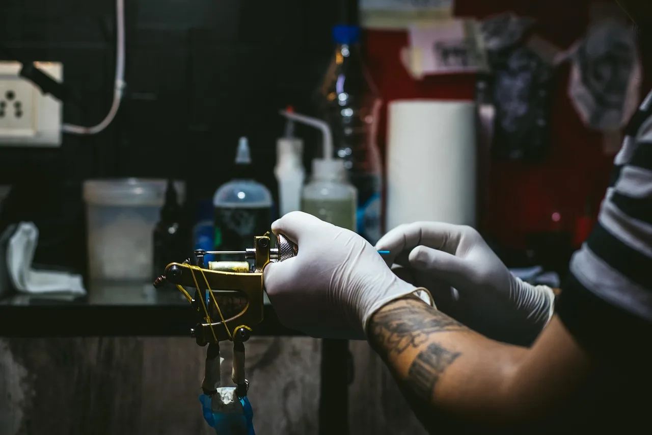 artist, tattoo, creative, tattooist, tattooing, machine, fashion, salon, skin, studio, culture, professional, lifestyle, master, body, hand, drawing, design, sterile, man, black, gloves, process, pain, ink, female, create, caucasian, concentration, needle, woman, tool, technician, style, arm, tattoo, tattoo, tattoo, tattoo, tattoo, salon, technician, technician. 1099 vs W-2 for US tattoo studios, IRS rules and liability choices