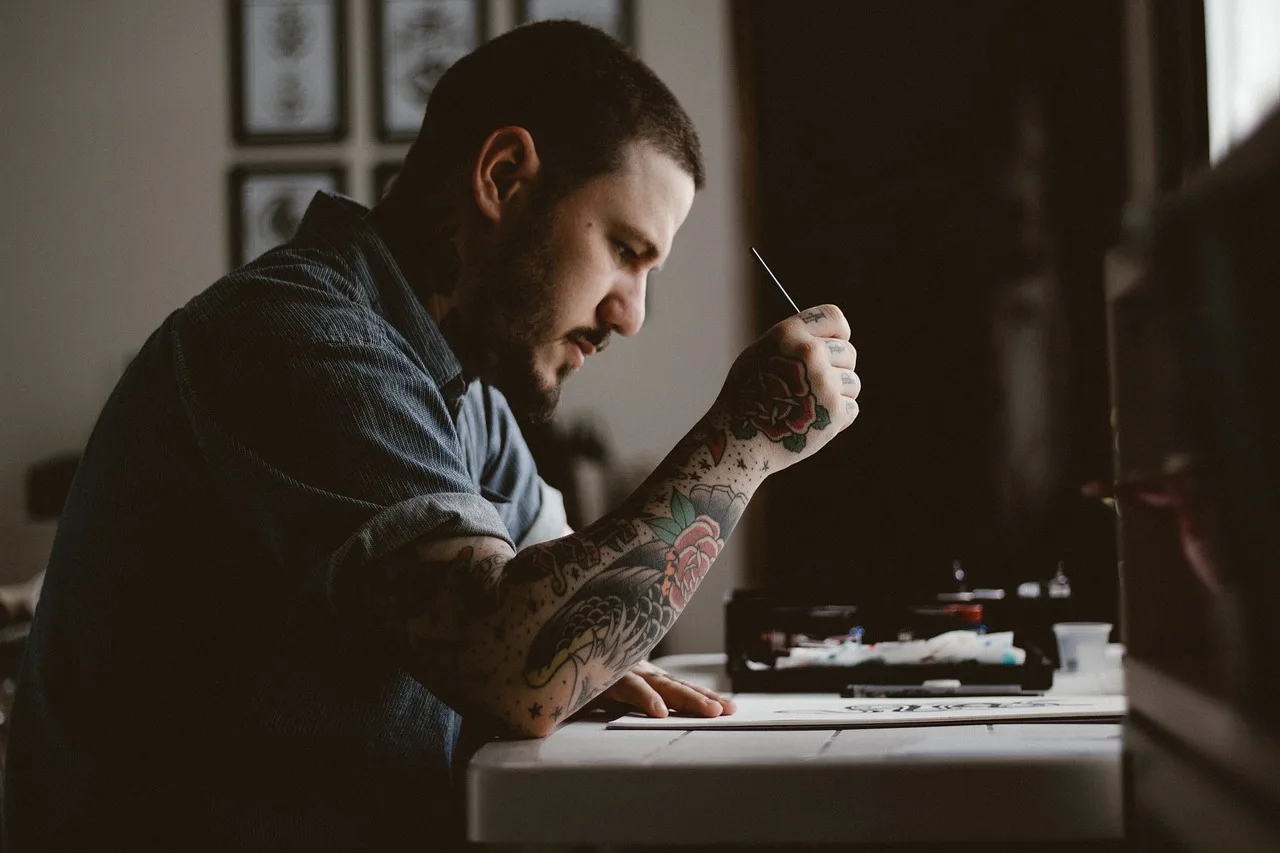 people, man, tattoo, drawing, design, artist, art, pen, paper, table, brown paper, brown art, brown table, brown design, brown drawing, tattoo, tattoo, tattoo, tattoo, tattoo. Tattoo Artist License Requirements in Florida: A Step-by-Step Guide