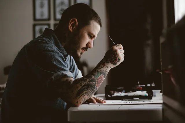 people, man, tattoo, drawing, design, artist, art, pen, paper, table, brown paper, brown art, brown table, brown design, brown drawing, tattoo, tattoo, tattoo, tattoo, tattoo. Tattoo Artist License Requirements in Florida: A Step-by-Step Guide